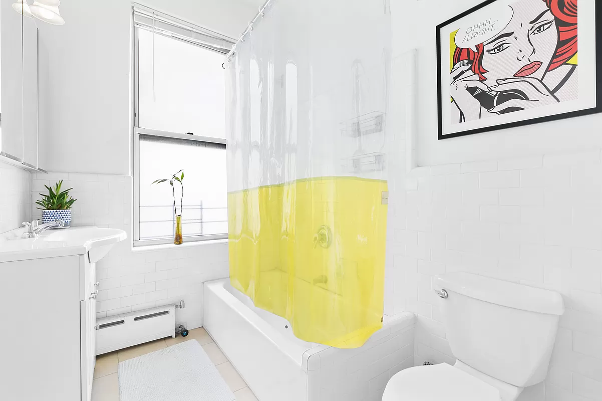 57 West 58th Street, Unit 8E Manhattan, NY 10019 - Photo 6 of 8 a bathroom with a sink and bathtub with toilet