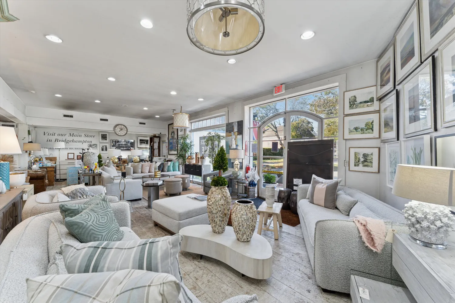 a living room with furniture a fireplace and a chandelier