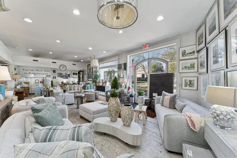 a living room with furniture a fireplace and a chandelier