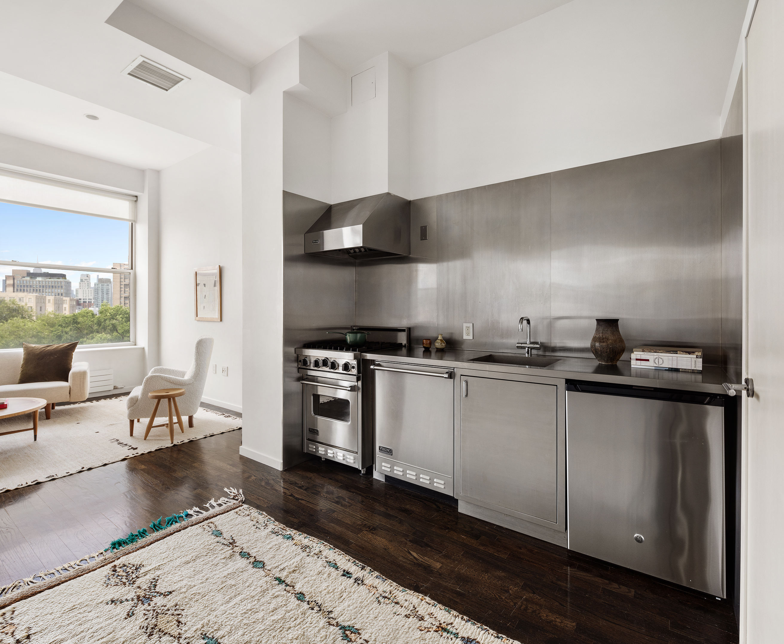 175 East Broadway, Unit 6A Manhattan, NY 10002 - Photo 3 of 11 a kitchen with granite countertop a stove and white cabinets