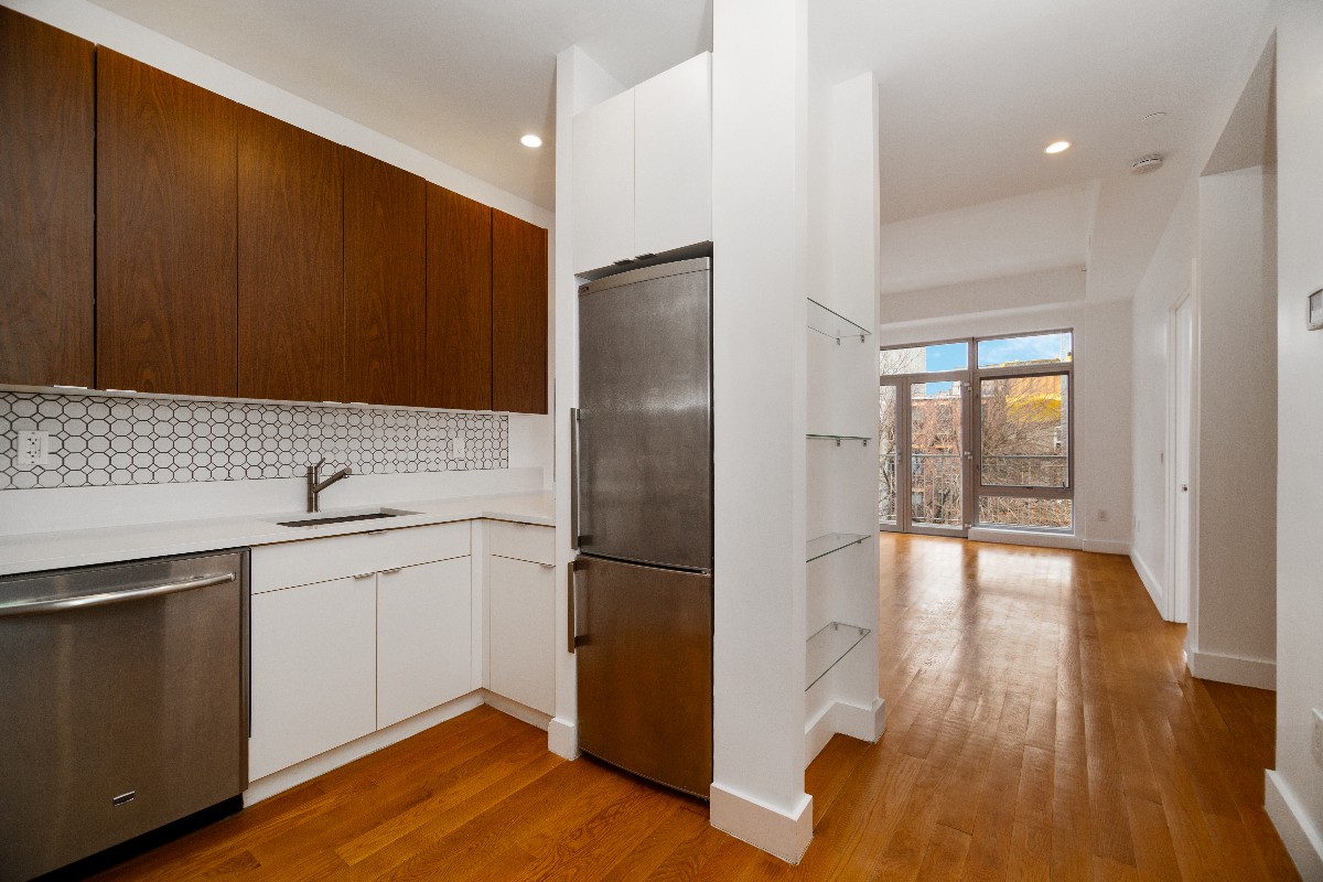 659 Bergen Street, Unit 3D Brooklyn, NY 11238 - Photo 2 of 7 a kitchen with a refrigerator and a sink