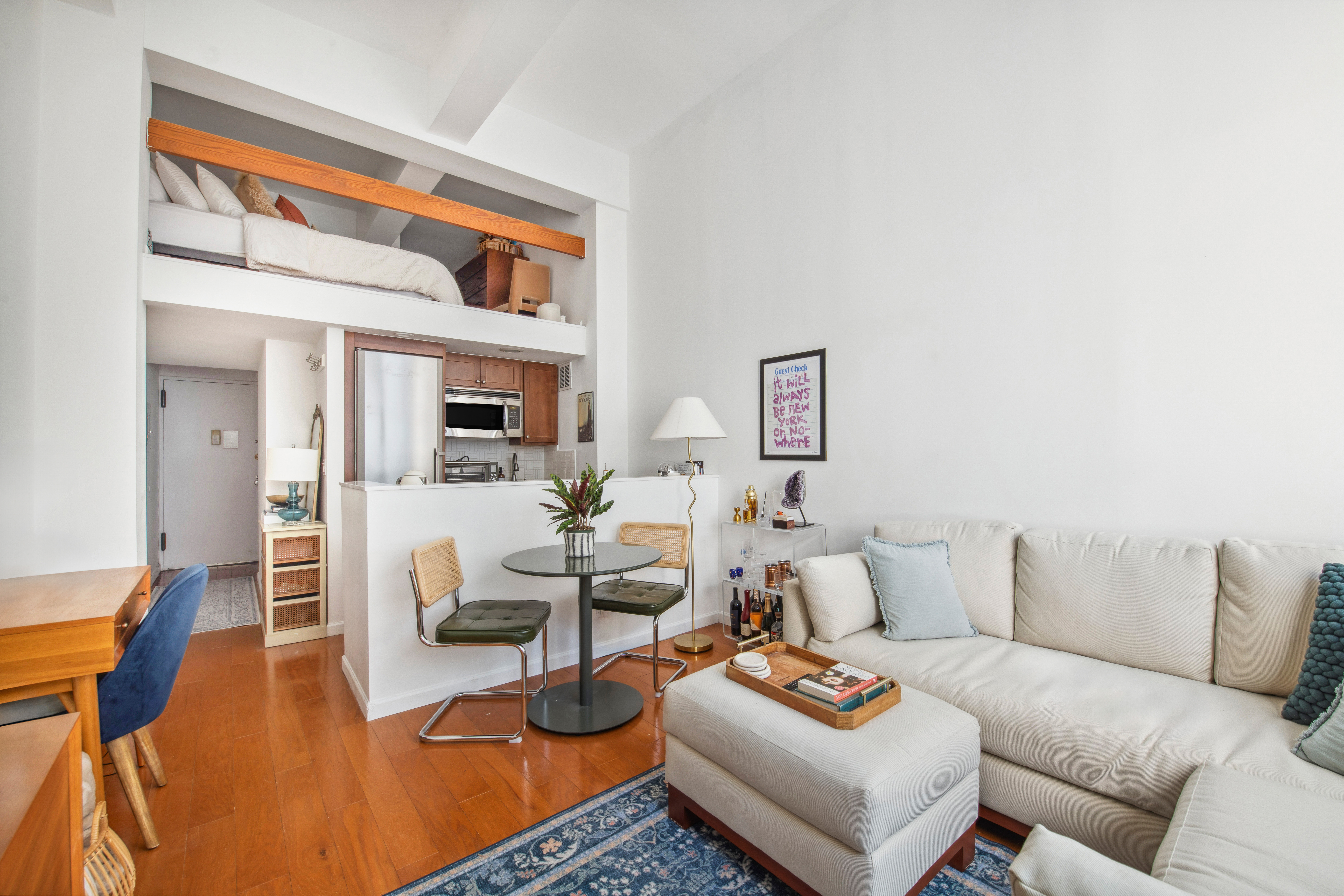 350 East 62nd Street, Unit 3J Manhattan, NY 10065 - Photo 2 of 9 a living room with furniture a rug and a table