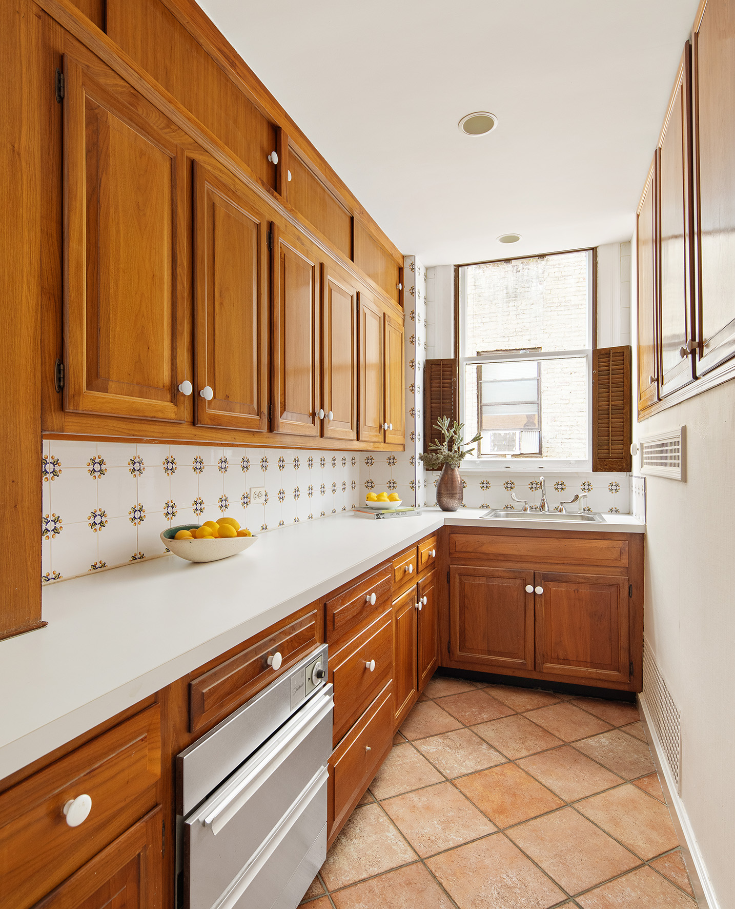 953 5th Avenue, Unit 7/8 Manhattan, NY 10075 - Photo 13 of 15 a kitchen with granite countertop cabinets stainless steel appliances a sink and a window