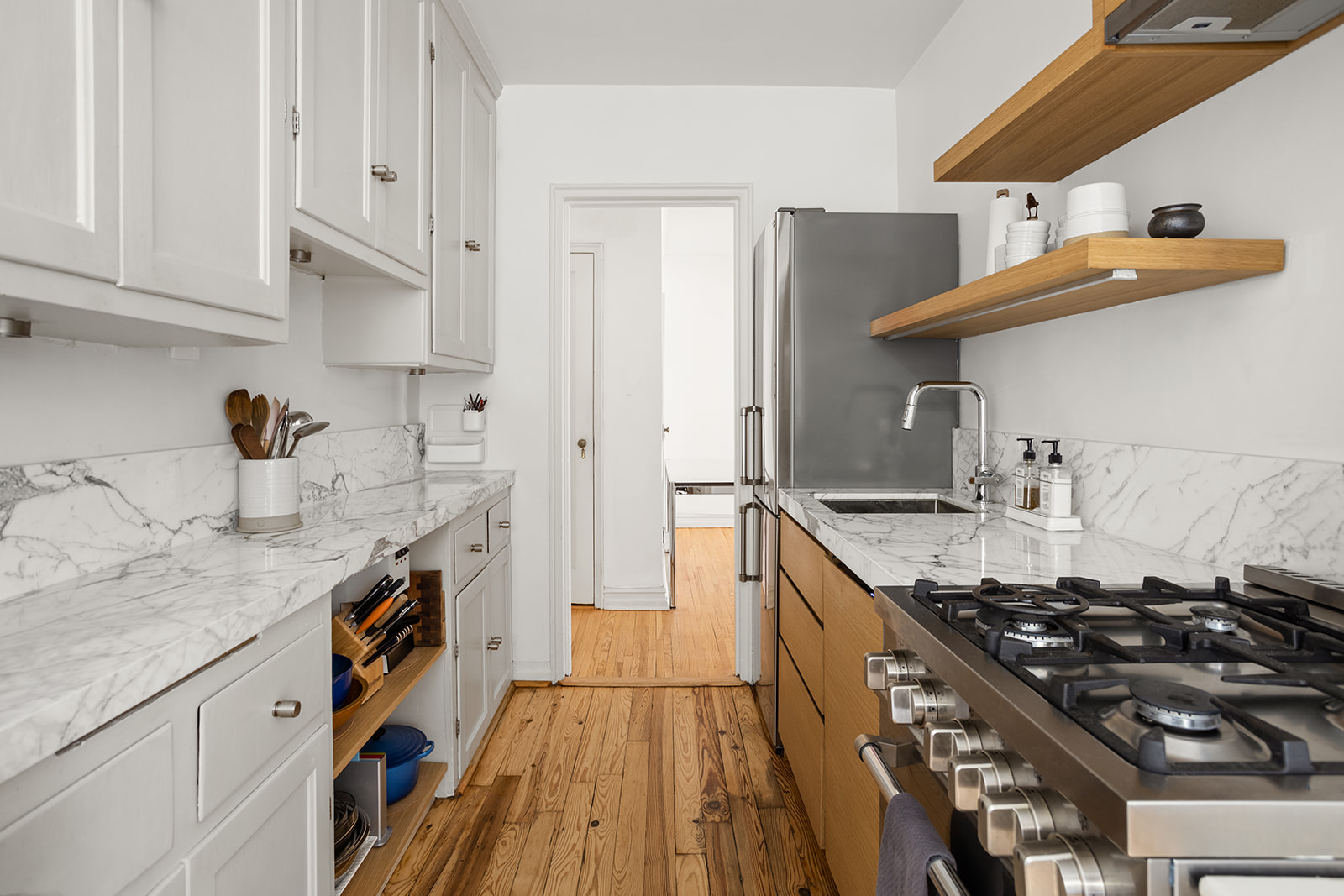 35-36 76th Street, Unit 123 Queens, NY 11372 - Photo 5 of 11 a kitchen with stainless steel appliances a sink stove and refrigerator
