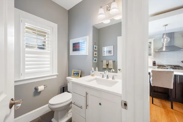 a bathroom with a sink toilet and a mirror