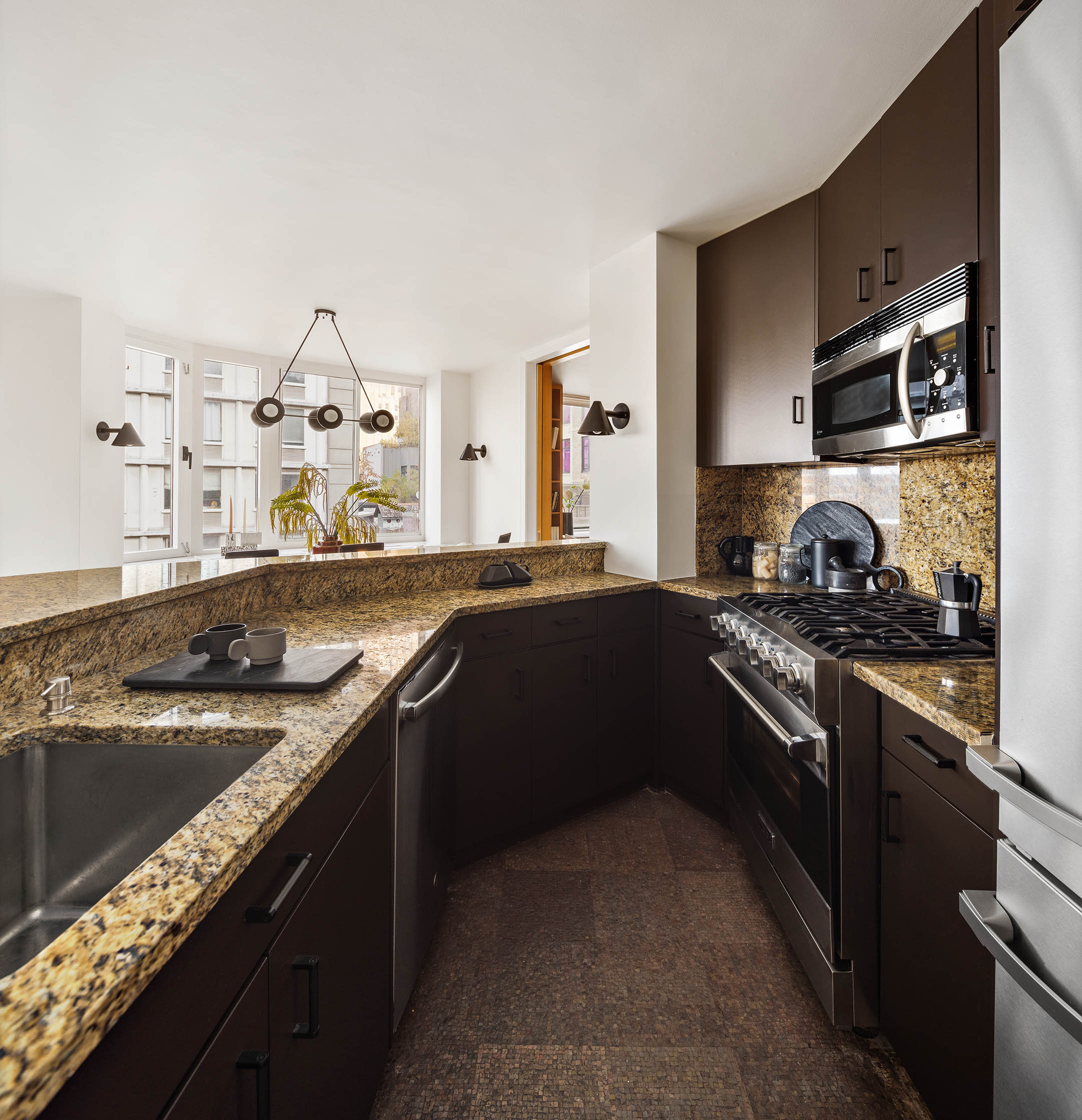 295 Greenwich Street, Unit 8/9H Manhattan, NY 10007 - Photo 5 of 22 a kitchen with stainless steel appliances granite countertop a sink stove and cabinets