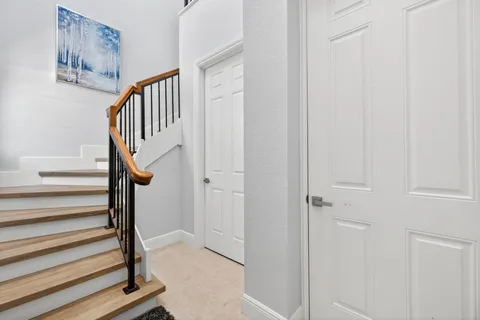 a view of entryway with wooden floor and stairs