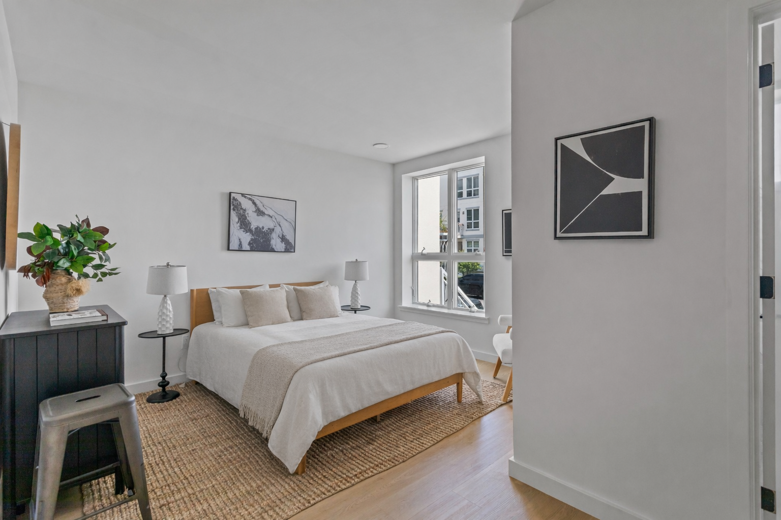 3112 Emmons Avenue, Unit 3124A2 Brooklyn, NY 11235 - Photo 5 of 17 a bedroom with a bed and a potted plant