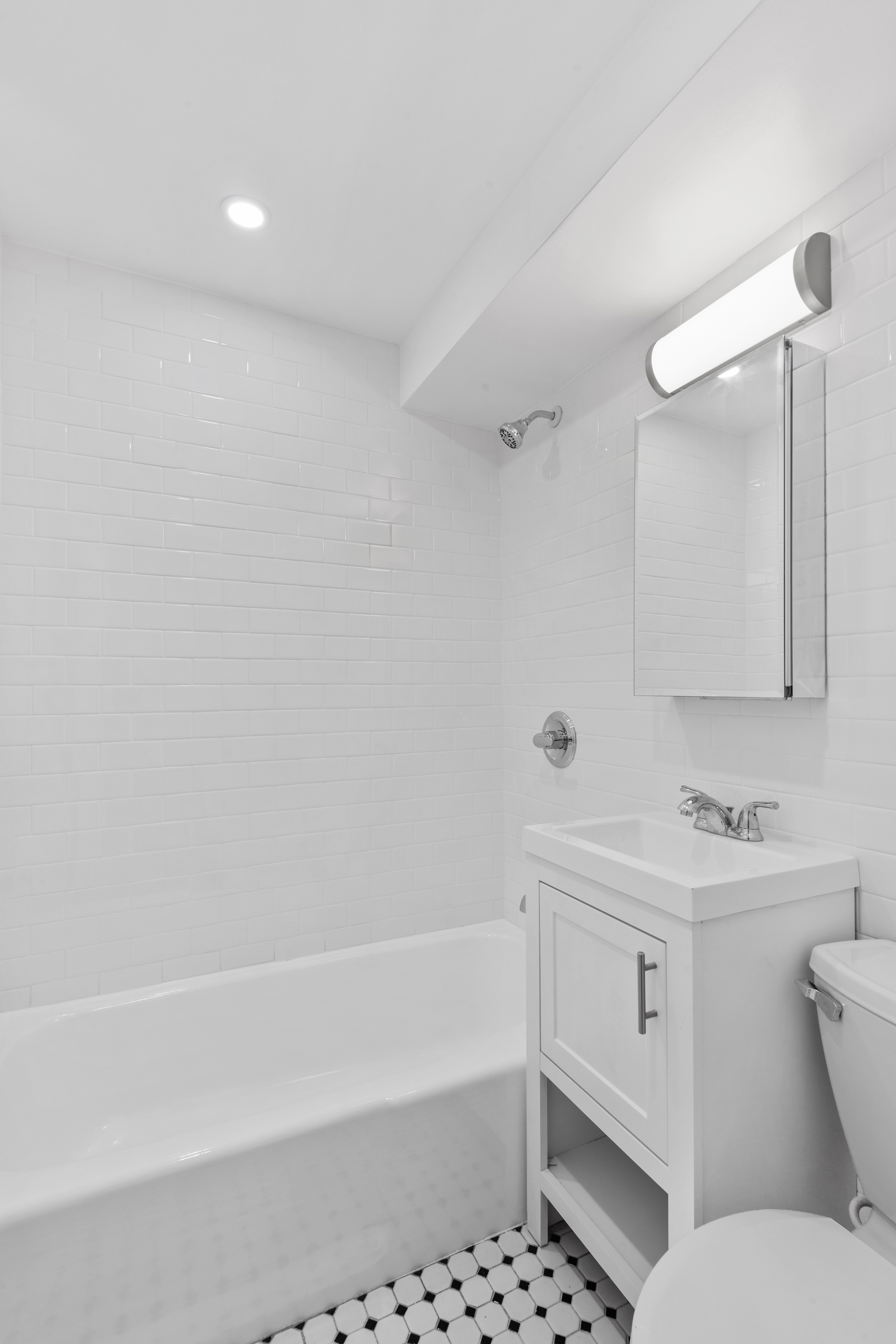 15 Jones Street, Unit 3C Manhattan, NY 10014 - Photo 4 of 5 a bathroom with a sink a toilet and shower