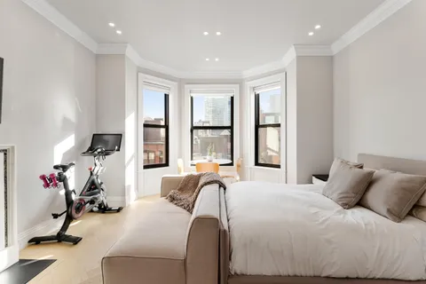 a bed room with a bed and a large window