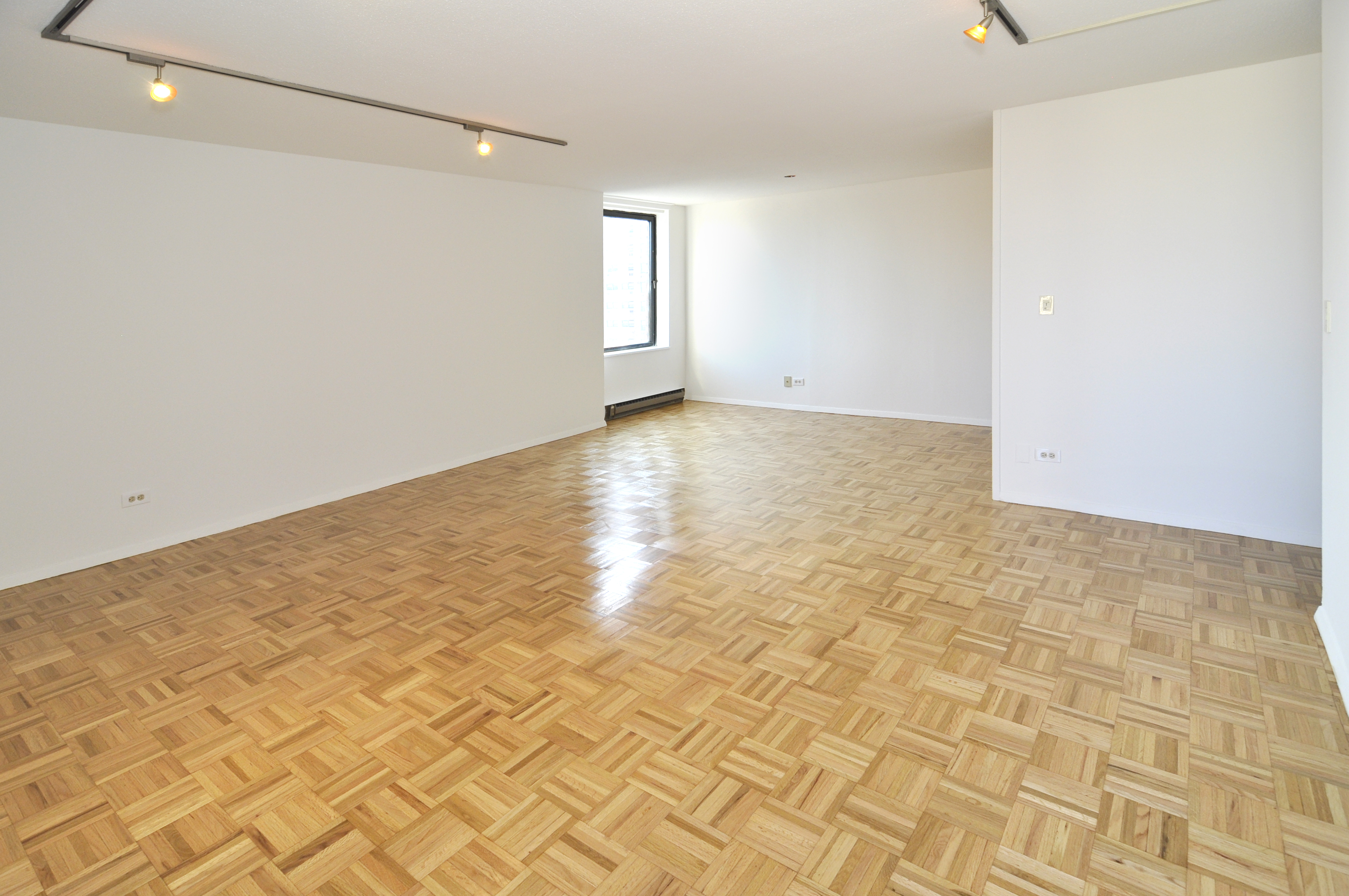1623 3rd Avenue, Unit 25C Manhattan, NY 10128 - Photo 9 of 12 a view of empty room with wooden floor and fan