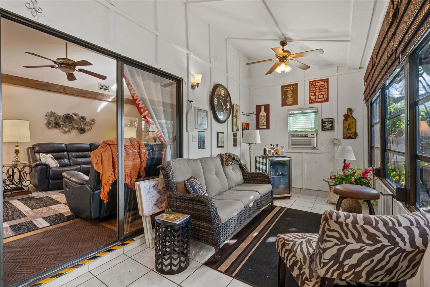 a living room with furniture and a floor to ceiling window