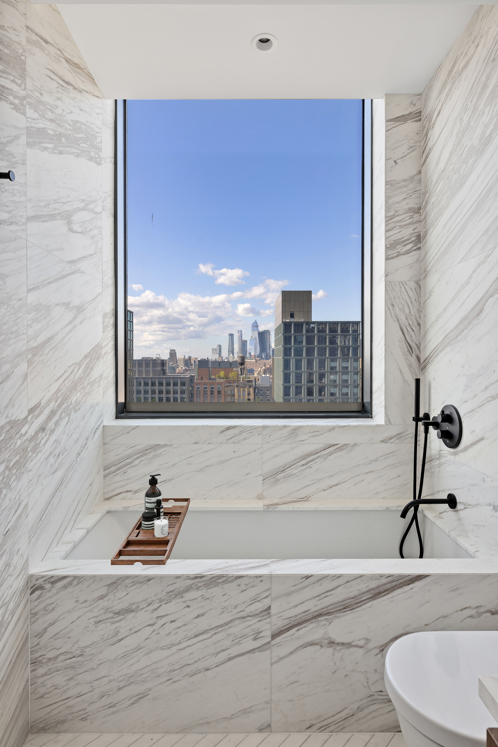 570 Broome Street, Unit 23A Manhattan, NY 10013 - Photo 10 of 13 a bathroom with a sink a toilet and a window