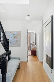 a view of a bedroom with furniture and wooden floor