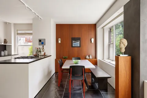 a view of a dining room with furniture and window