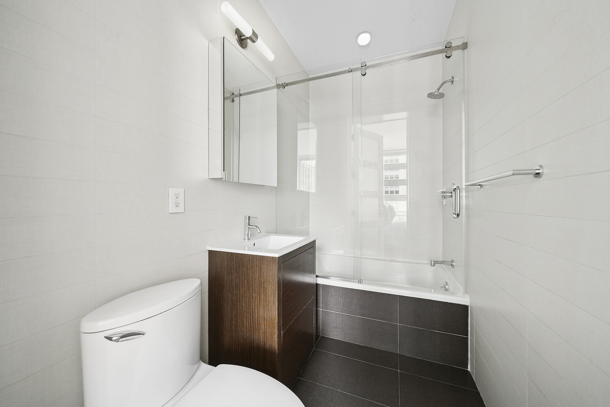 148 East 19th Street, Unit 4B Manhattan, NY 10003 - Photo 5 of 10 a bathroom with a sink a toilet and shower