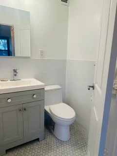 a bathroom with a sink toilet and vanity