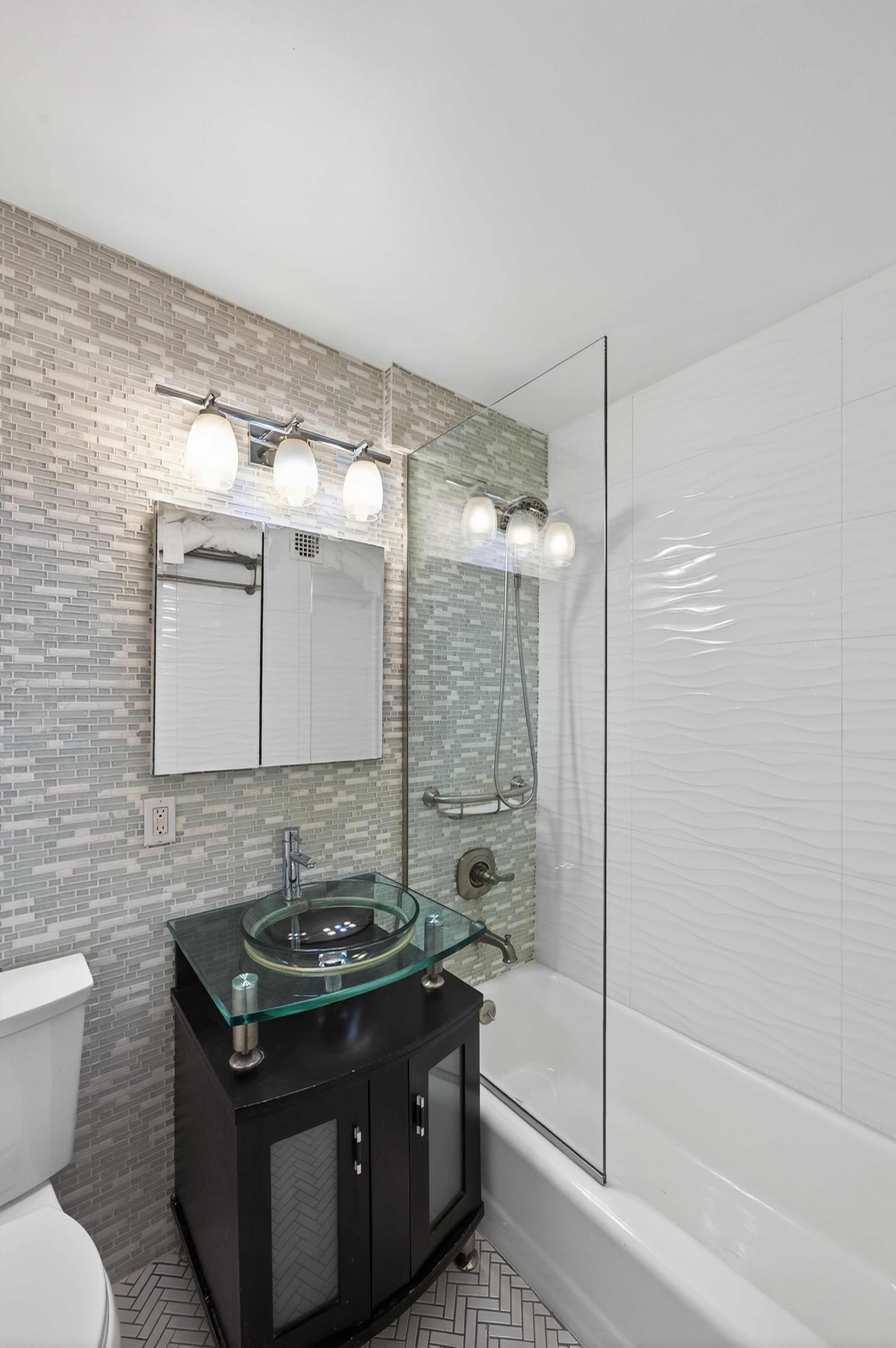 330 3rd Avenue, Unit 8A Manhattan, NY 10010 - Photo 9 of 13 a bathroom with a granite countertop sink toilet and shower