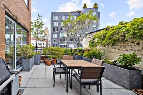 a view of a patio with a table and chairs in patio