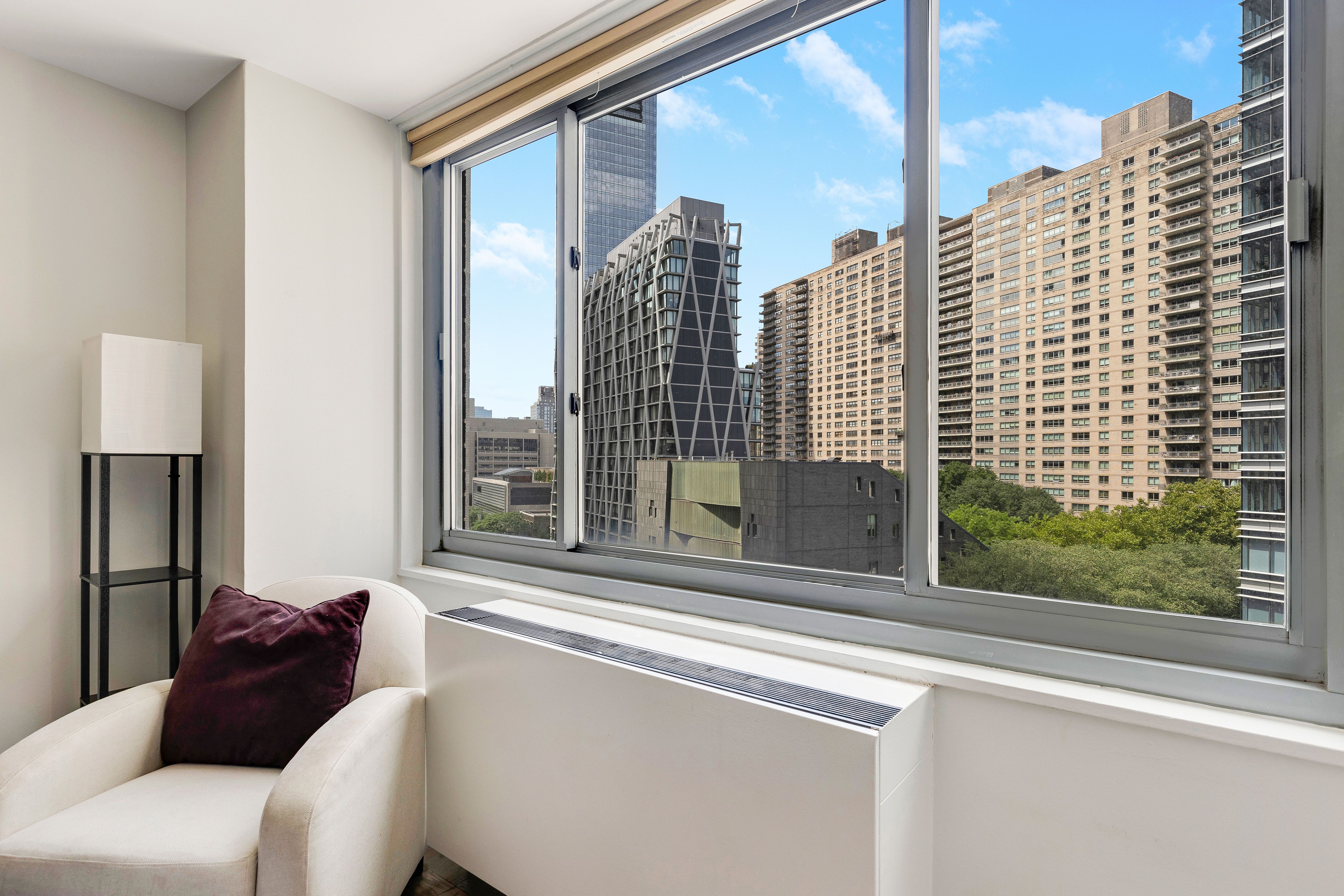2025 Broadway, Unit 7AB Manhattan, NY 10023 - Photo 2 of 13 a living room with a couch and a large window