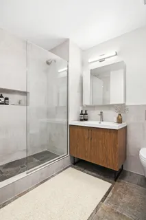 a bathroom with a tub a sink and mirror