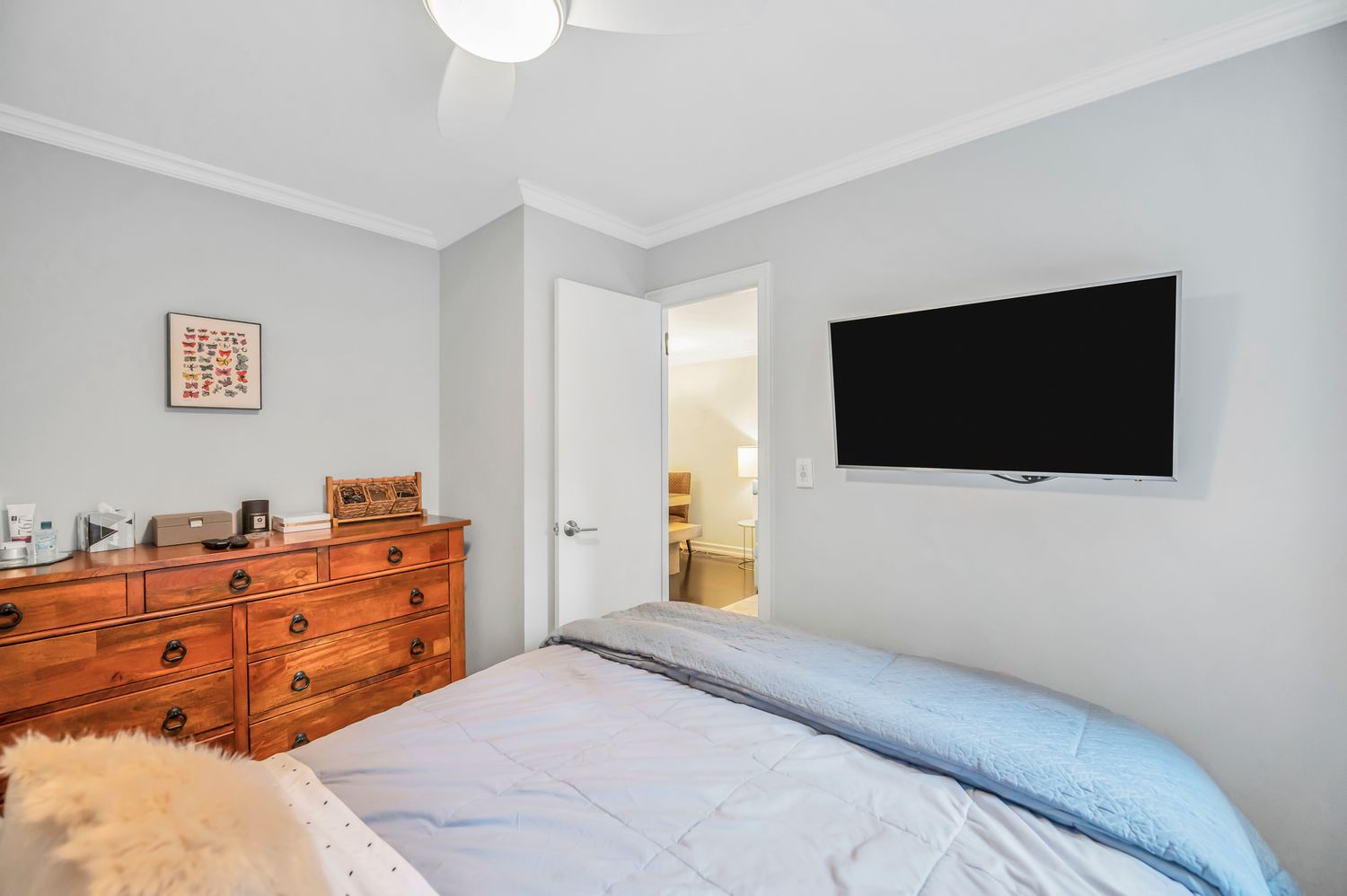 333 East 79th Street, Unit 2R Manhattan, NY 10075 - Photo 8 of 13 a bedroom with a bed and a flat screen tv