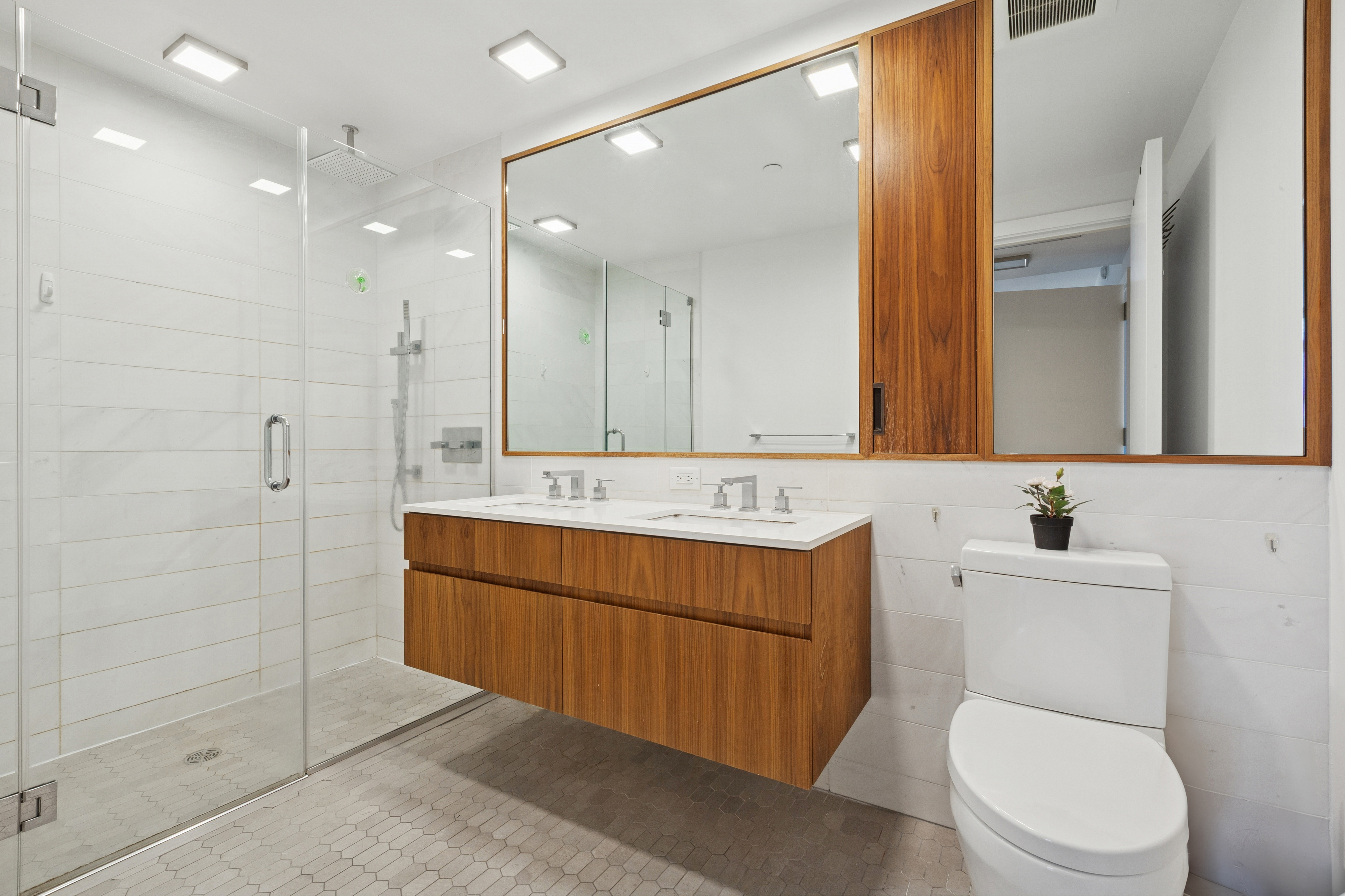 319 Schermerhorn Street, Unit 19B Brooklyn, NY 11217 - Photo 6 of 13 a bathroom with a sink a toilet and mirror