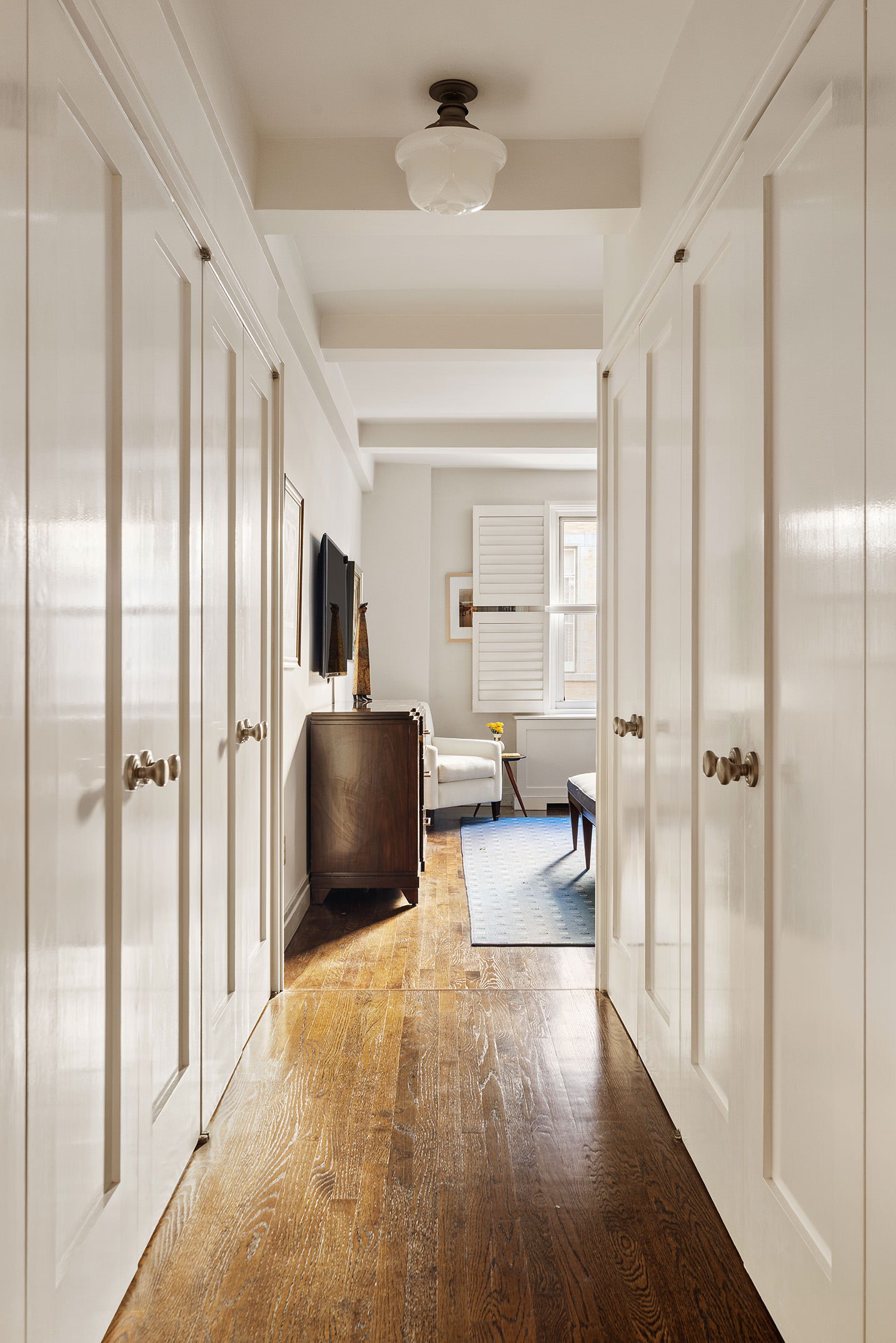 450 West End Avenue, Unit 3B Manhattan, NY 10024 - Photo 8 of 13 a living room with furniture and a chandelier