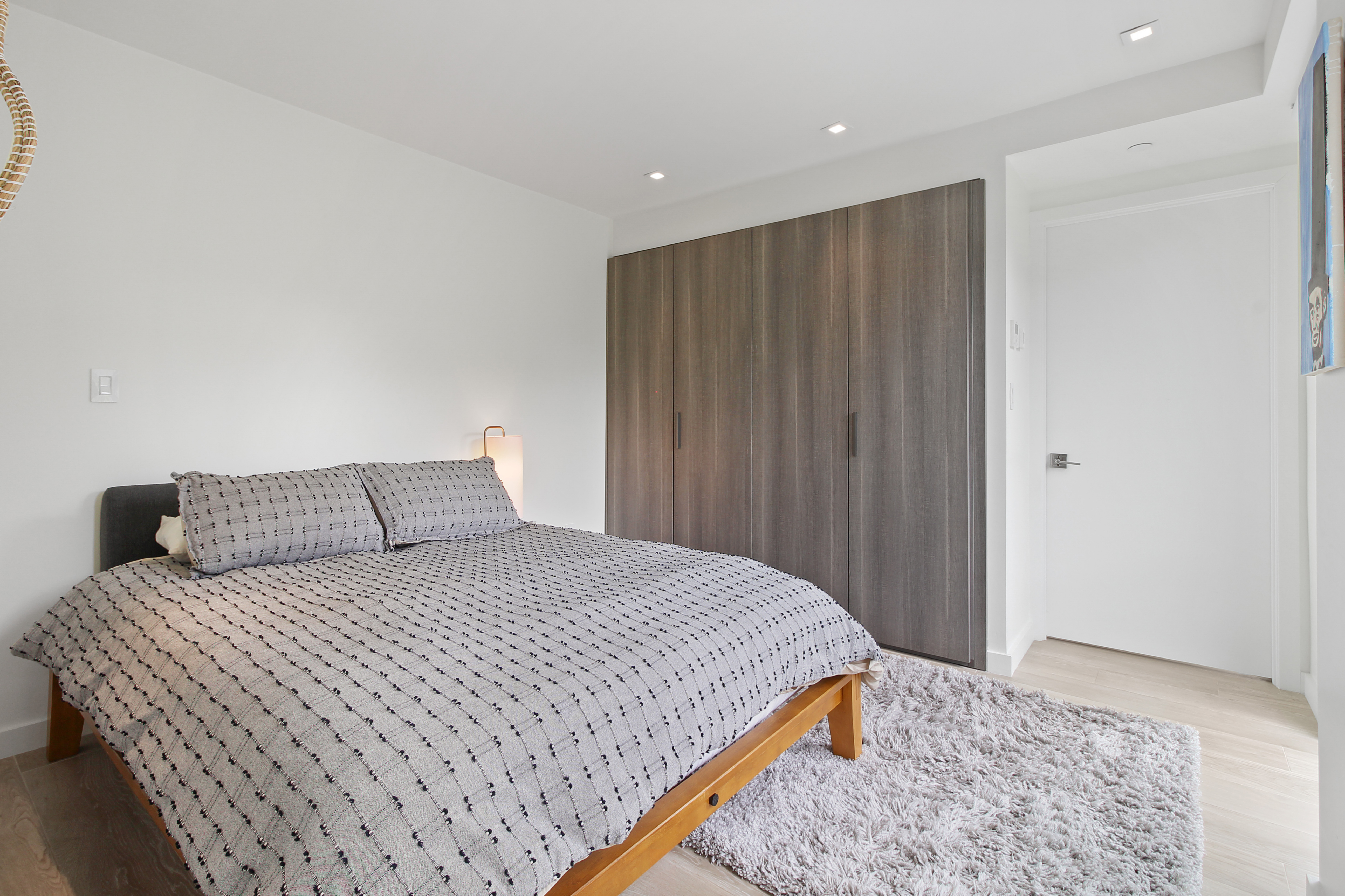 136 West Houston Street, Unit 4 Manhattan, NY 10012 - Photo 11 of 14 a bedroom with a bed and wooden floor