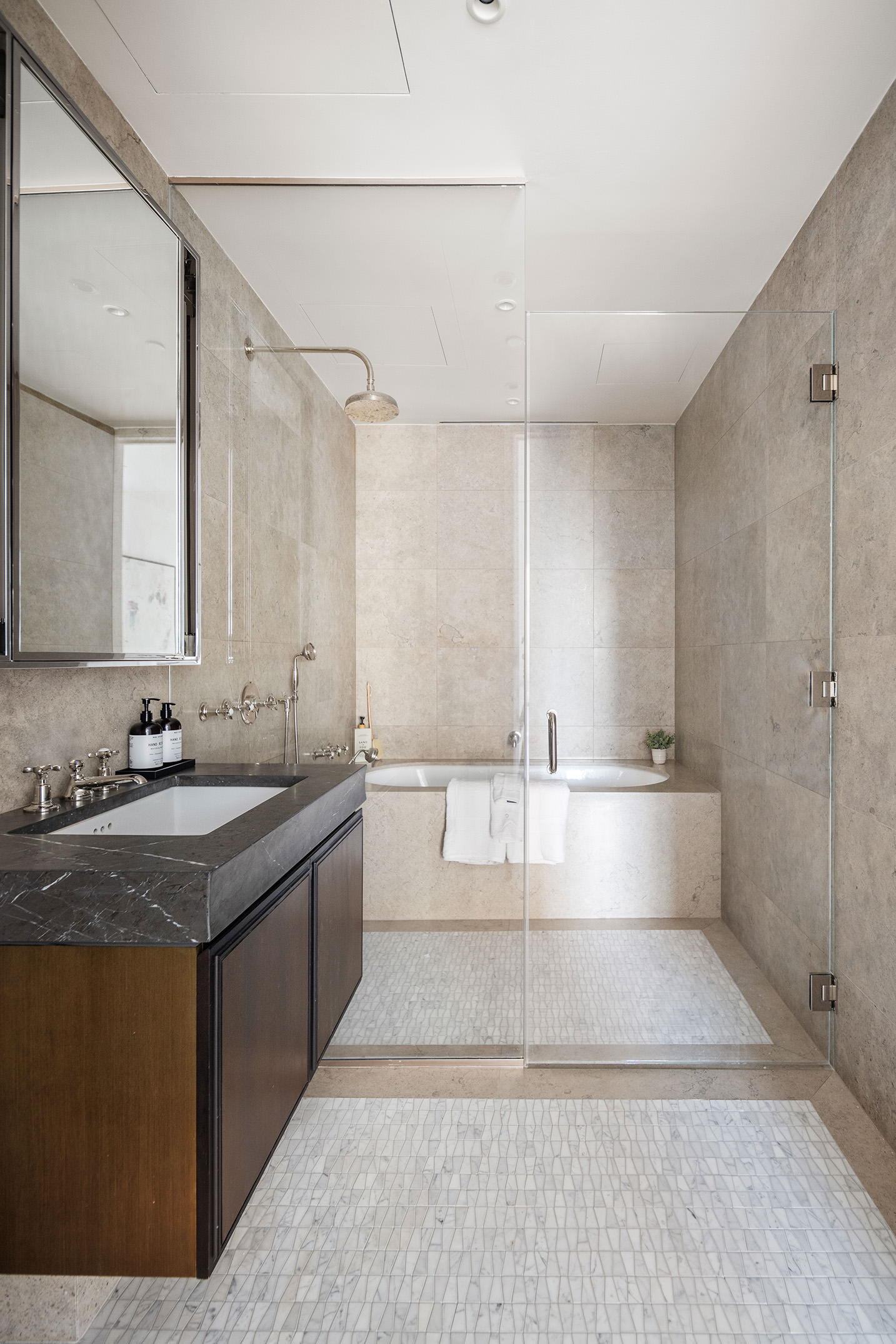 5 Beekman Street, Unit 21B Manhattan, NY 10038 - Photo 10 of 23 a large bathroom with a tub a sink and mirror