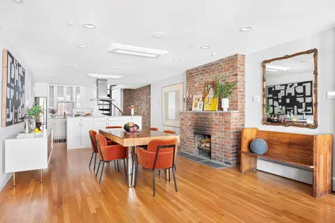 a dining room with furniture and wooden floor