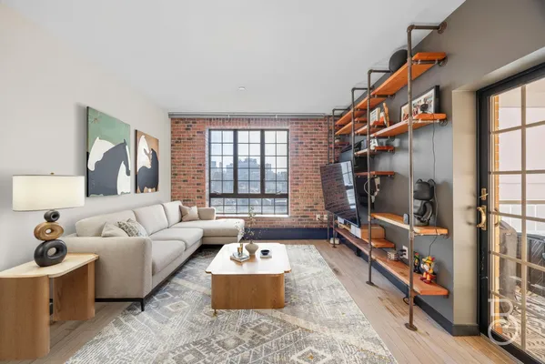 a living room with furniture fireplace and a window