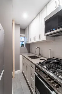 a kitchen with stainless steel appliances granite countertop a stove and a sink