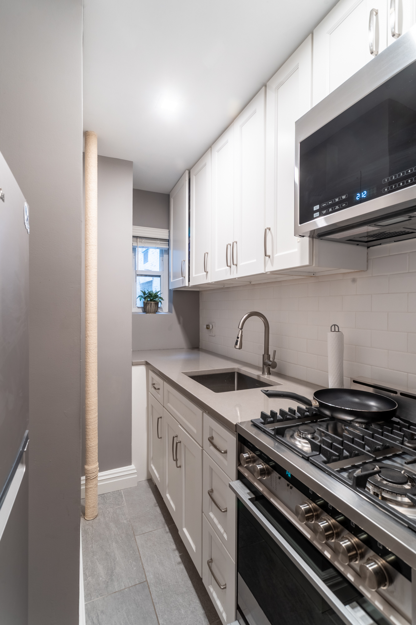 235 West 102nd Street, Unit 3T Manhattan, NY 10025 - Photo 6 of 10 a kitchen with stainless steel appliances granite countertop a stove and a sink