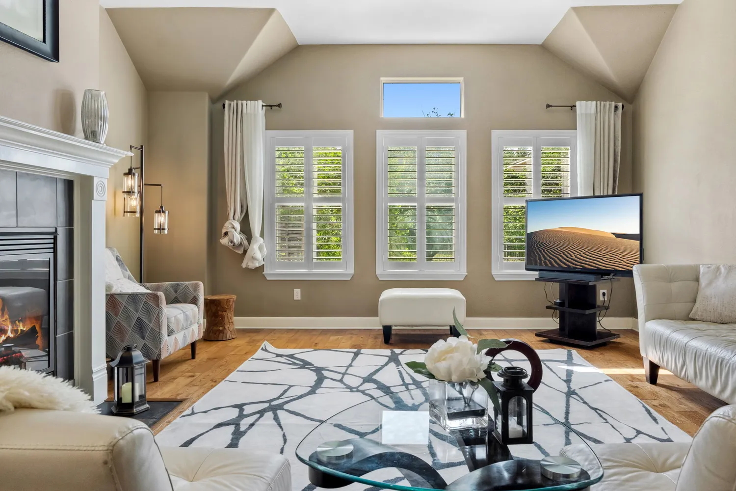 a living room with furniture couches and a large window
