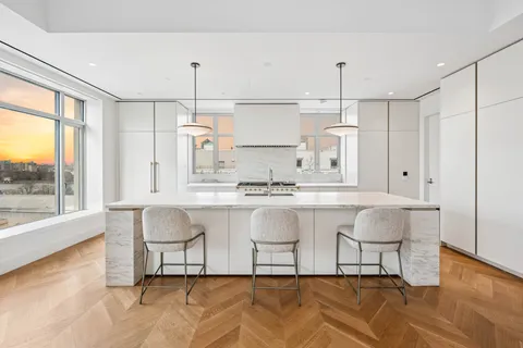 a kitchen with a table chairs stove and kitchen view