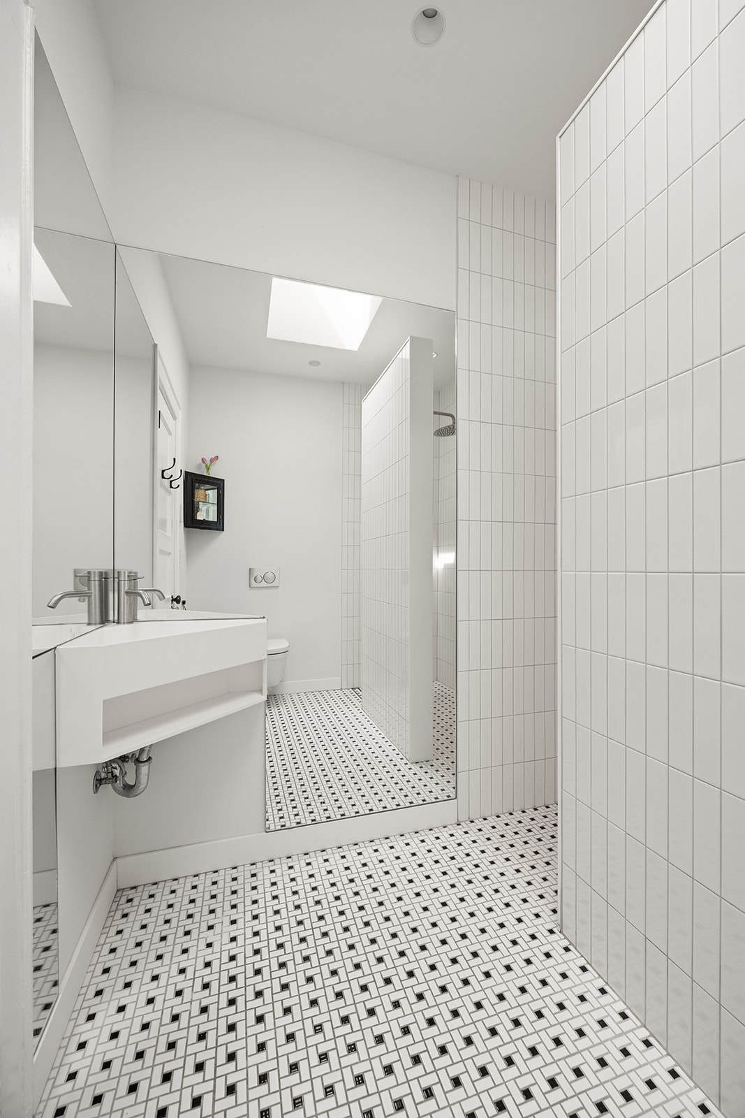 125 Rutland Road Brooklyn, NY 11225 - Photo 9 of 22 a bathroom with a sink a toilet a mirror and shower