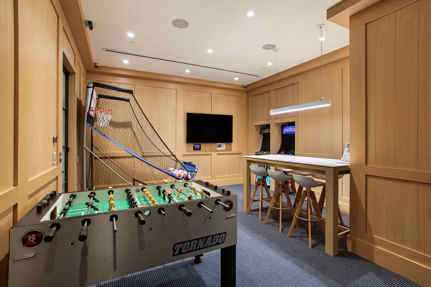 a room with table tennis pool table and glass door