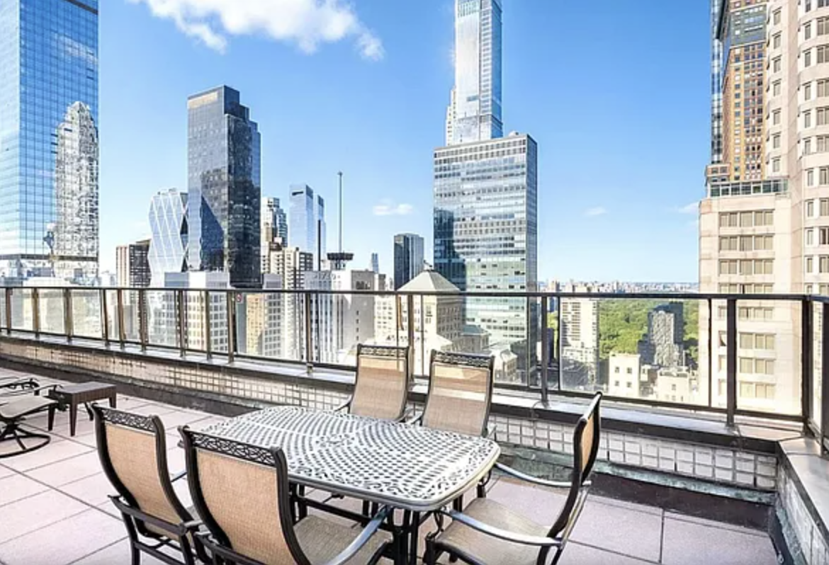 159 West 53rd Street, Unit 36C Manhattan, NY 10019 - Photo 6 of 9 a view of a balcony with two chairs and a table with potted plants