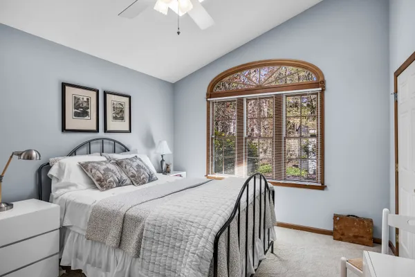 a bedroom with a bed and a chandelier