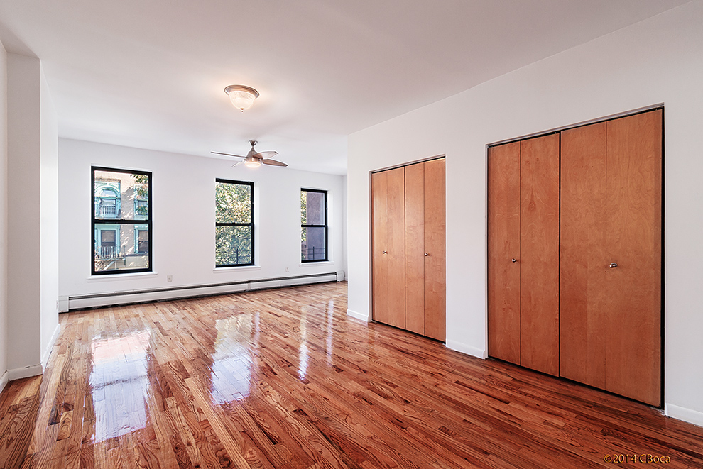 404 Classon Avenue, Unit 2 Brooklyn, NY 11238 - Photo 3 of 14 an empty room with wooden floor and windows