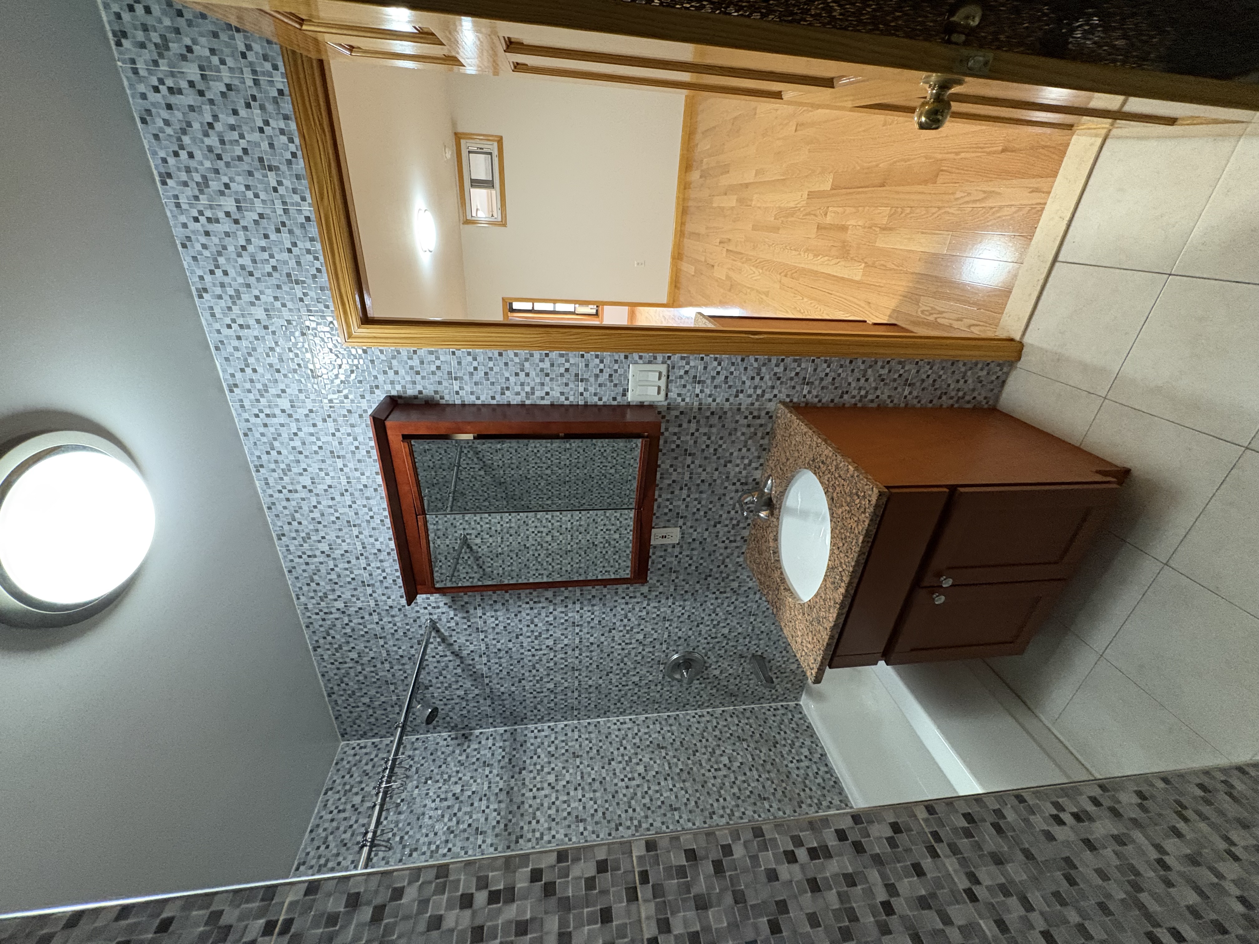 38 Ludlow Street, Unit 15 Manhattan, NY 10002 - Photo 14 of 16 a spacious bathroom with a tub sink and mirror