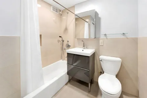 a white toilet sitting next to a bathroom sink
