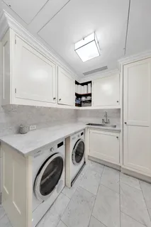 a utility room with cabinets washer and dryer
