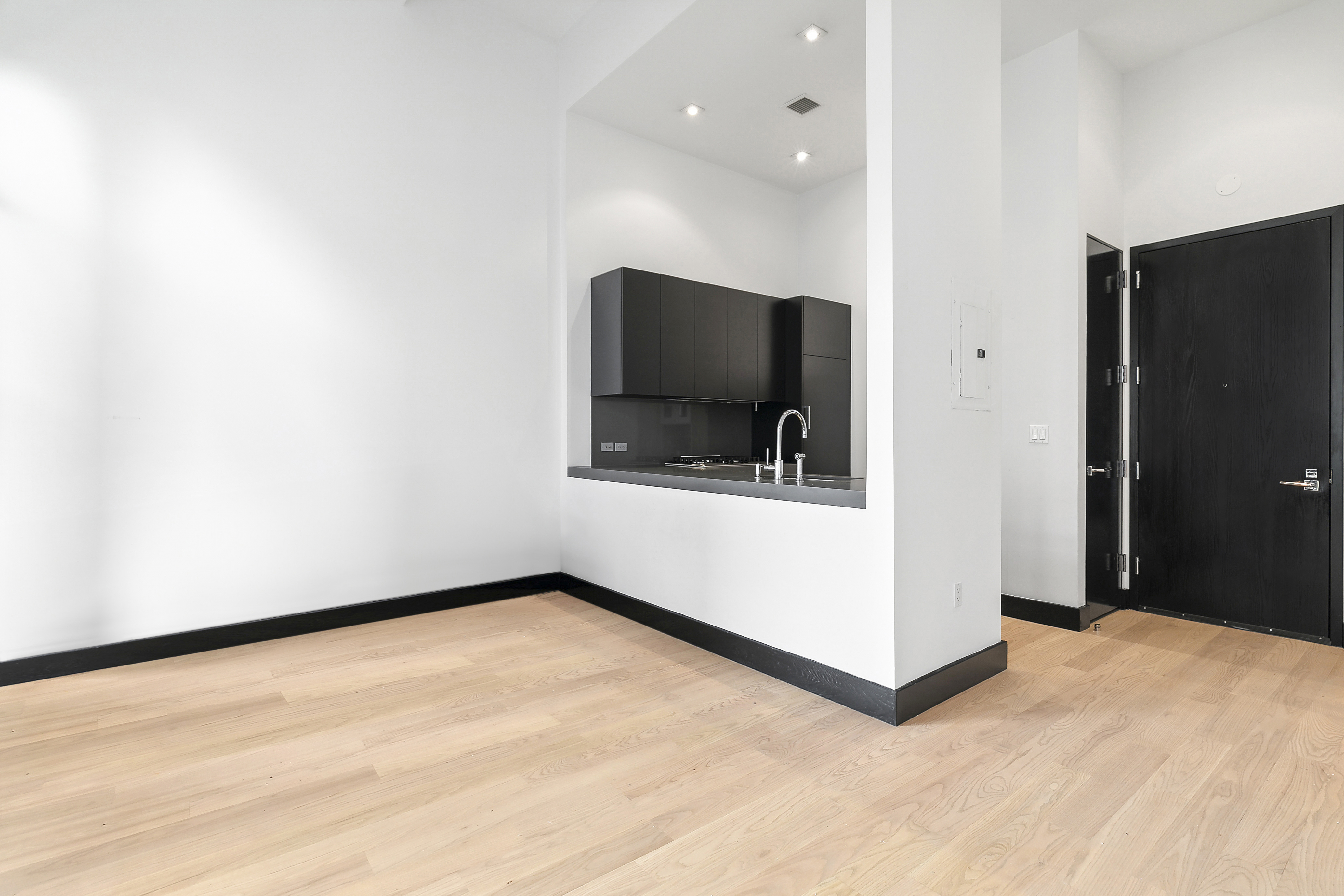 254 Park Avenue South, Unit 3C Manhattan, NY 10010 - Photo 4 of 9 a view of an empty room with a cabinet and a flat screen tv