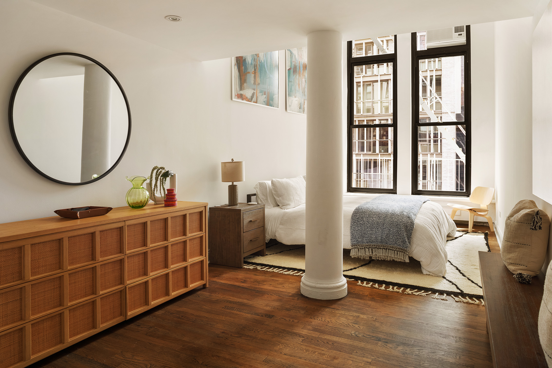 250 Mercer Street, Unit C302 Manhattan, NY 10012 - Photo 8 of 24 a living room with furniture a window and a potted plant