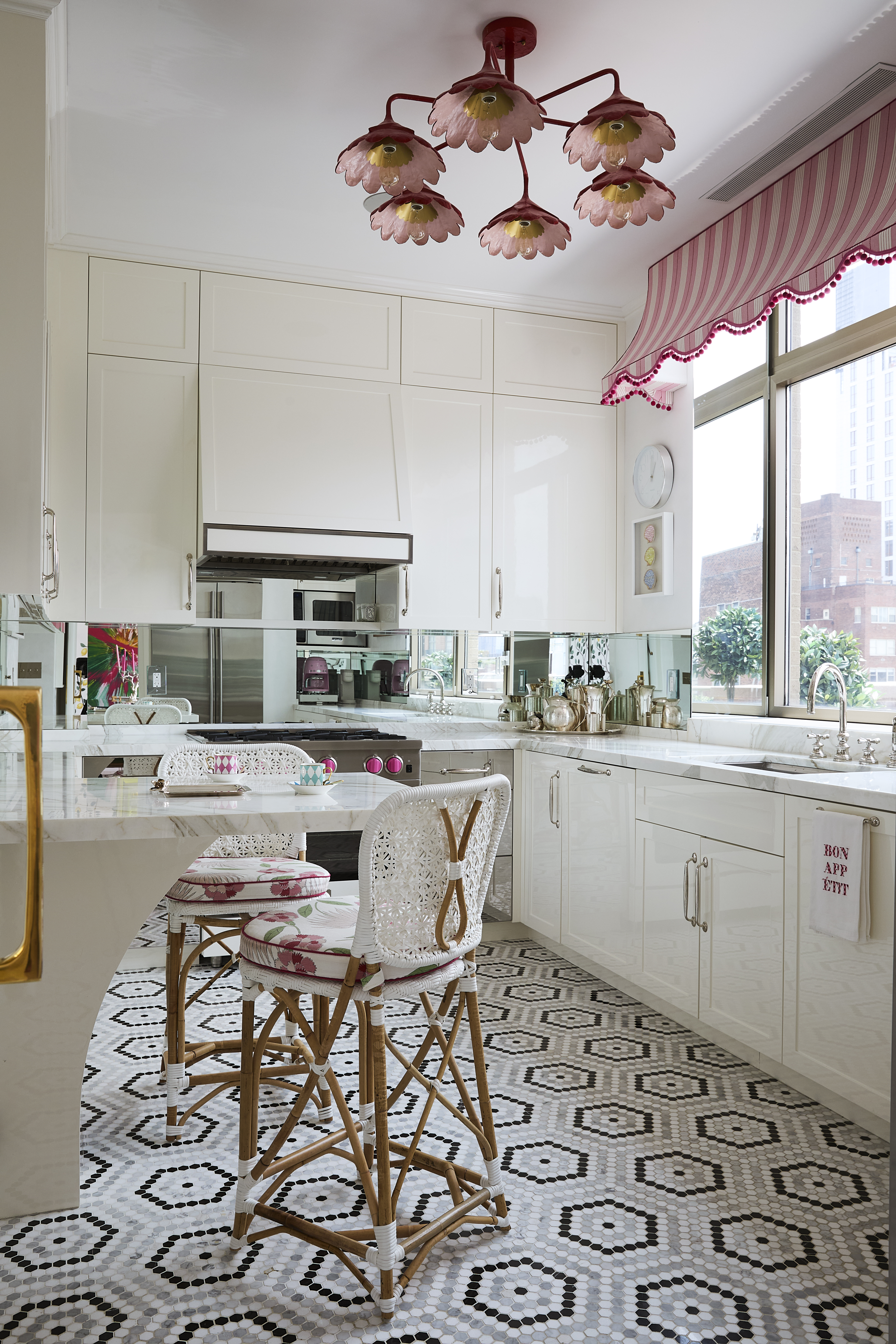 145 East 76th Street, Unit PH Manhattan, NY 10021 - Photo 12 of 25 a kitchen with a table chairs and a stove