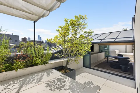 a view of a balcony with a table and chairs