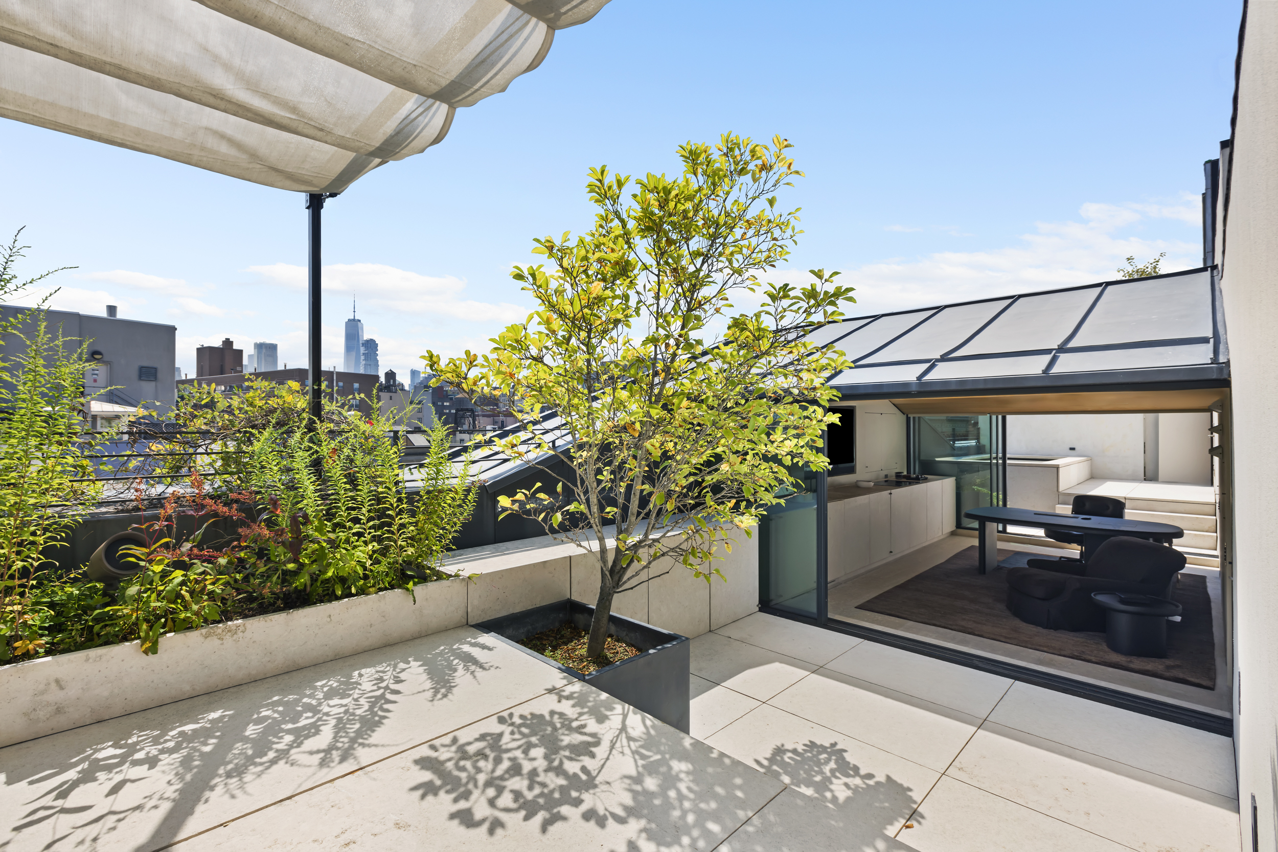 54 Bond Street, Unit PH Manhattan, NY 10012 - Photo 27 of 31 a view of a patio with table and chairs potted plants