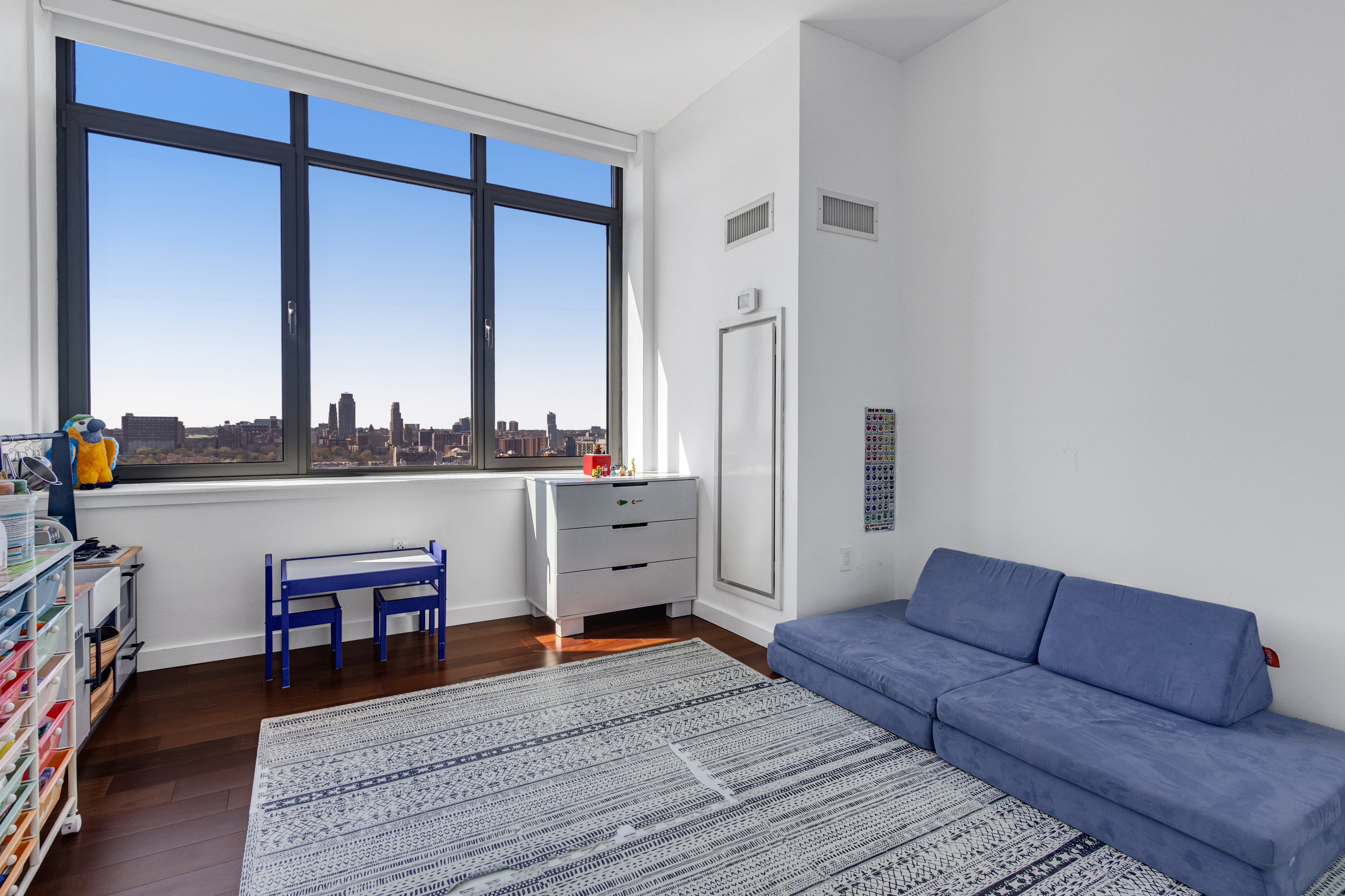 1485 5th Avenue, Unit 24F Manhattan, NY 10035 - Photo 6 of 16 a living room with furniture and a fireplace